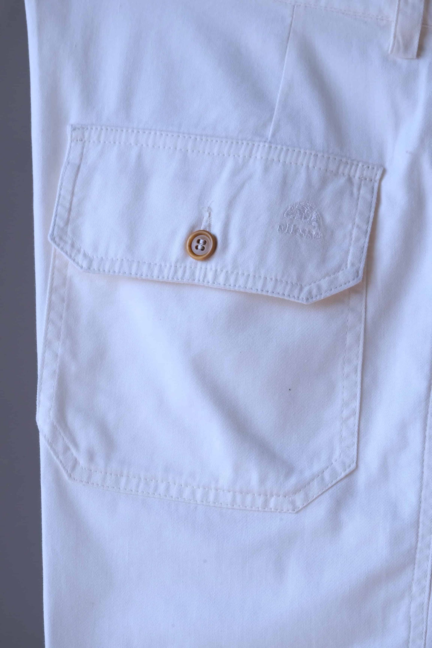 Close shot of the back pocket of vintage off-white ELLESSE Men's Bermuda Shorts