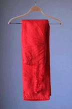 Vintage 70s Warmia ski bib photographed folded over a wooden hanger against a grey background.