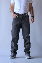 Front view of a person wearing Wrangler black wash straight-leg jeans.