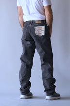rear view of a person wearing Wrangler black wash straight-leg jeans.