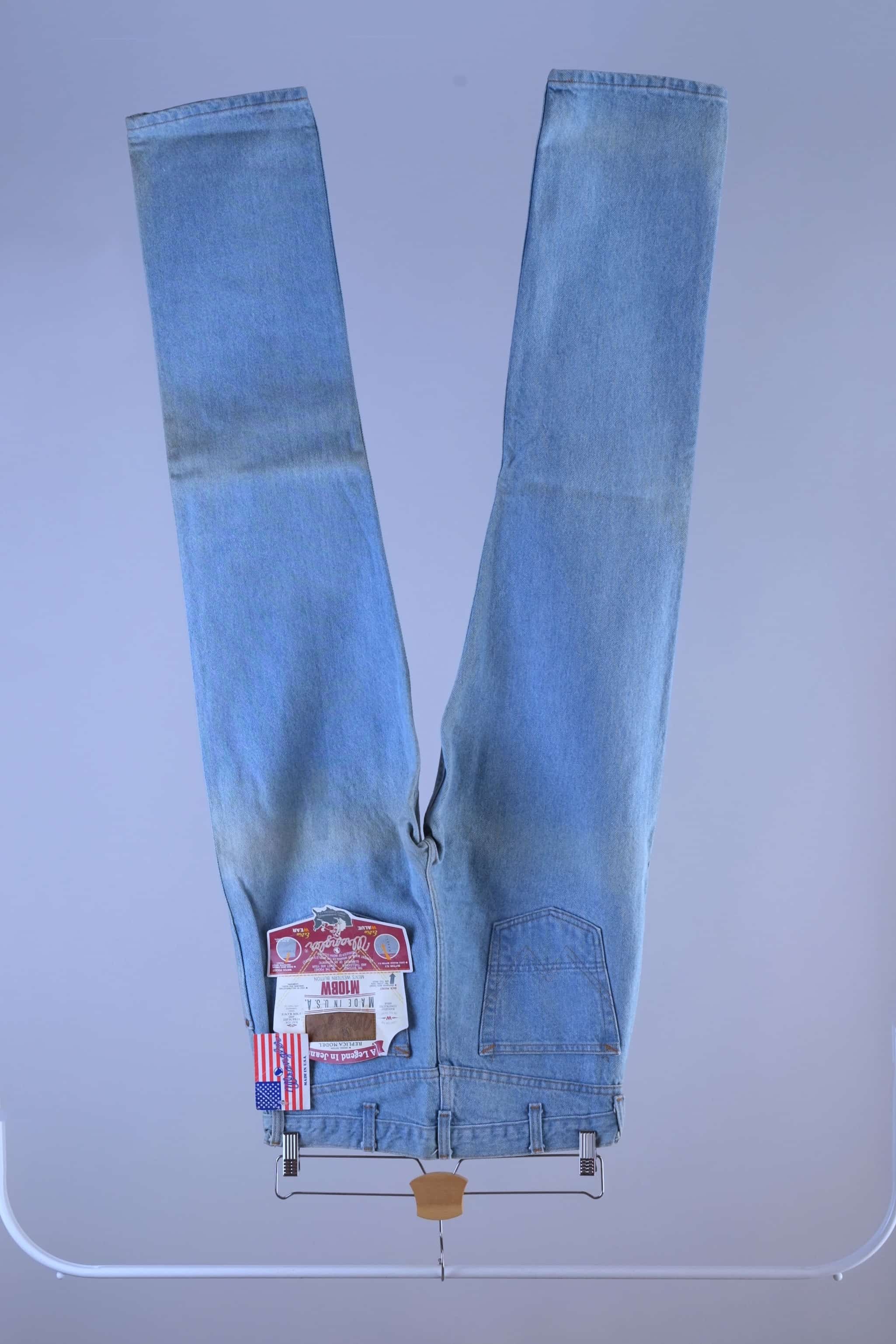 Full back profile of 90s WRANGLER light wash jeans hanging, showing the signature western "W" pocket stitching and straight cut.