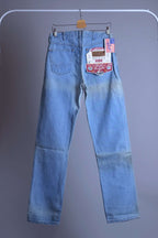Back view of WRANGLER M10BW vintage straight leg jeans on a hanger, showing original replica model tags and light wash denim.