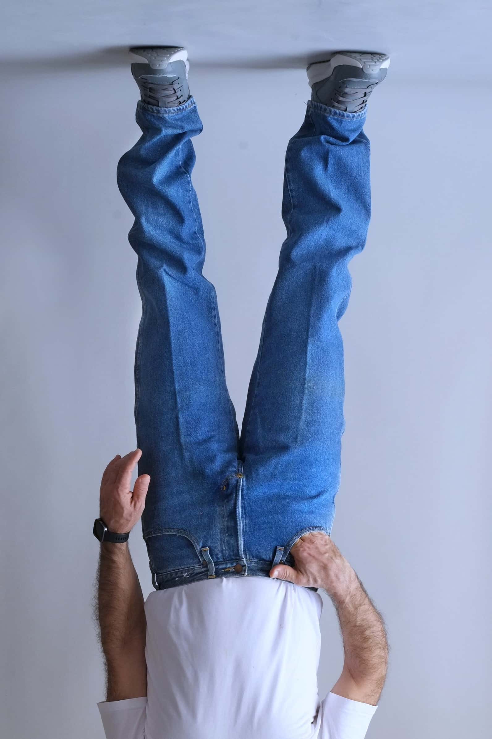 Front view of Wrangler medium-wash jeans with a straight-cut leg and crease detail.