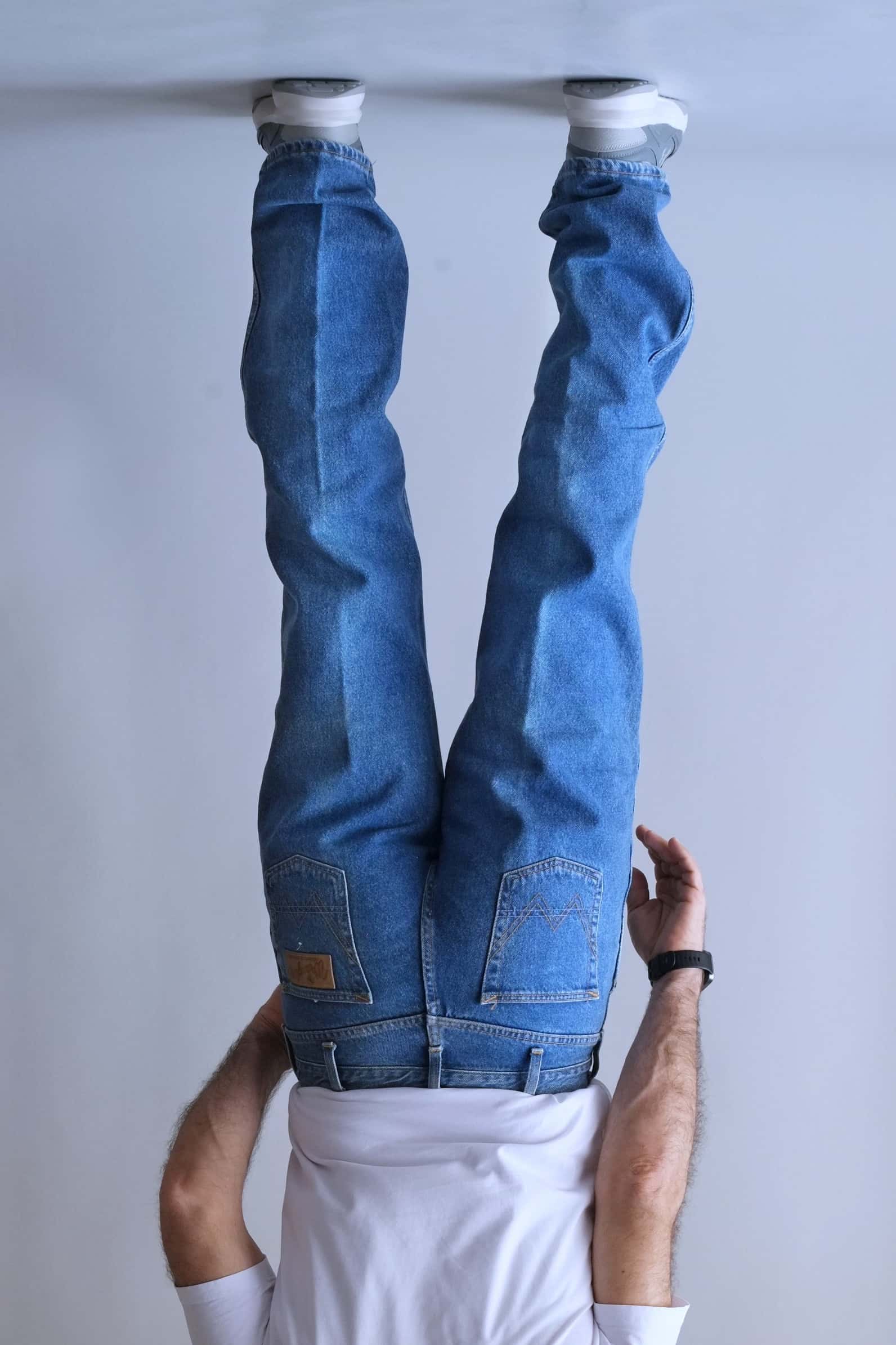 Rear view of Wrangler jeans showing the signature "W" pocket stitching and logo patch.