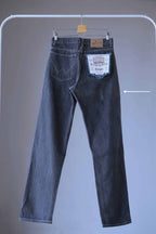 Back view of WRANGLER Vintage 90's Black Wash Jeans on hanger and showing an arrow pointing to some discoloration spot on the leg
