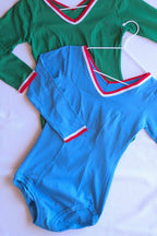 Zofina vintage 70s long sleeve leotards in green, and blue on white hangers.