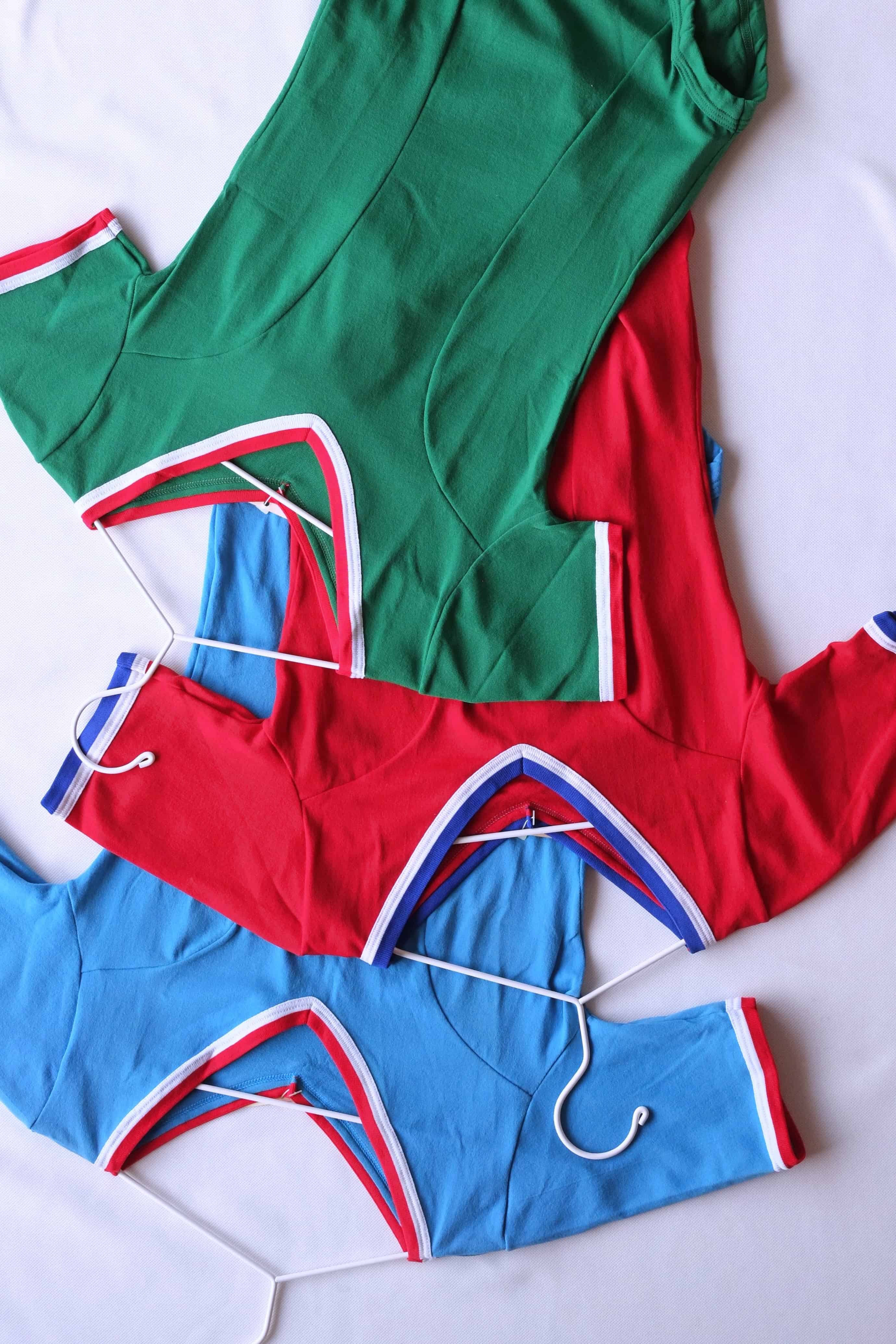 Zofina vintage 70s short sleeve leotards in red, green, and blue on white hangers.