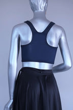 Back view of a Mannequin wearing a navy crop top against a plain background