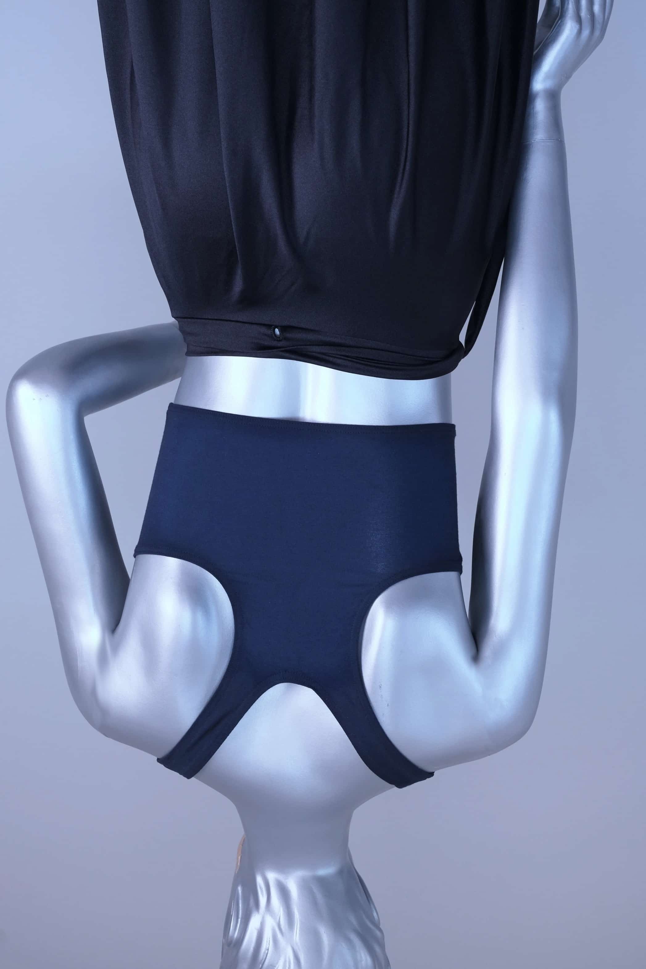 Back view of a Mannequin wearing a navy crop top against a plain background