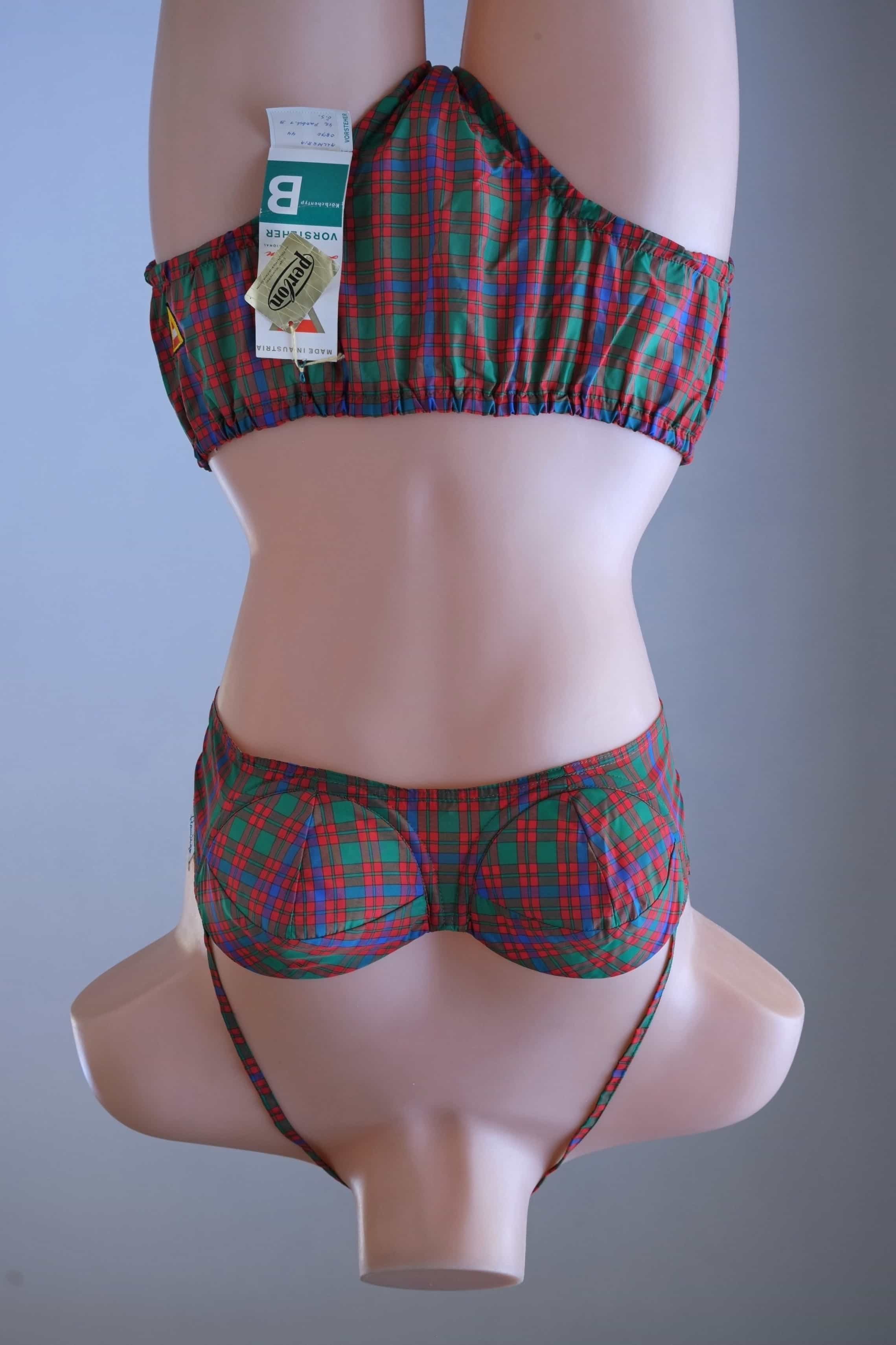 Front view of a vintage Flamingo tartan plaid two-piece bikini set on a mannequin, displaying original Vorsteher and Perlon hang tags on the high-waisted bottoms.