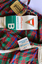 Close-up of the interior Vorsteher Wien Ladyform fabric label showing size 42, displayed next to paper hang tags on tartan plaid material.