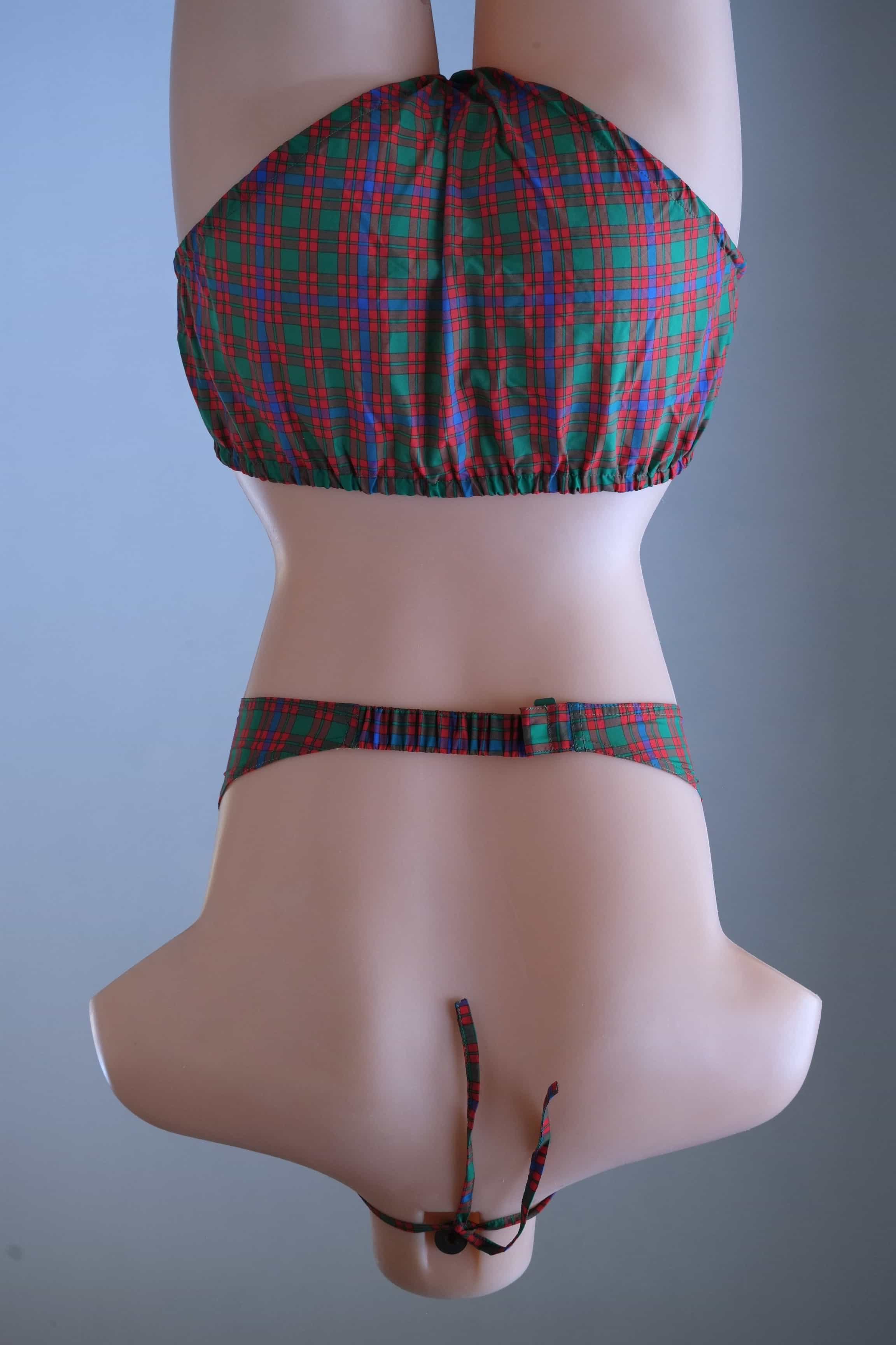 Rear view of a vintage tartan plaid two-piece bikini set on a mannequin, showing the back hook strap, tied halter neck, and high-waisted briefs.
