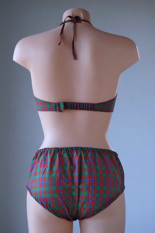 Rear view of a vintage tartan plaid two-piece bikini set on a mannequin, showing the back hook strap, tied halter neck, and high-waisted briefs.