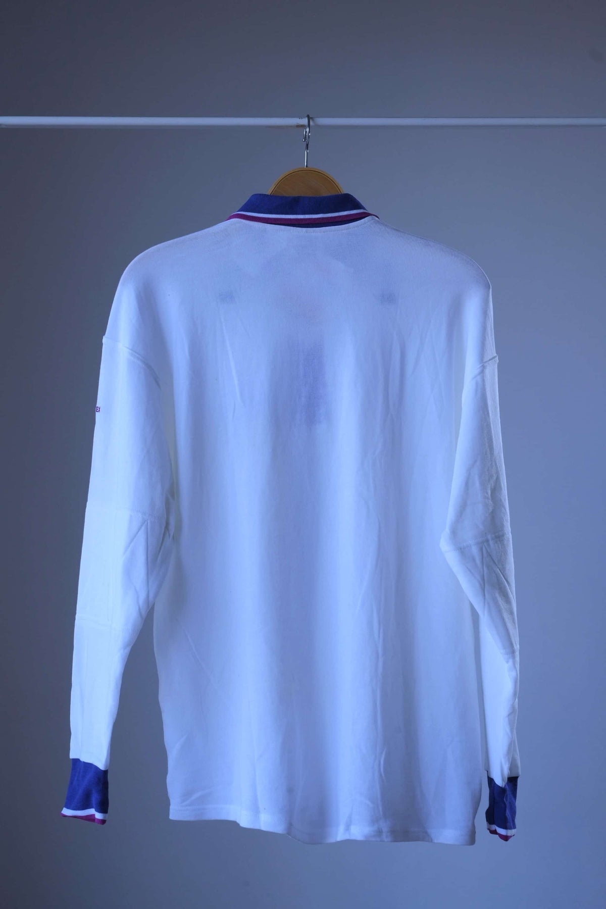 Back view of white Löffler 90s long-sleeve polo with purple collar and purple cuffs