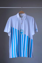 Löffler 90s men’s tennis polo in white with sky blue vertical stripes and a circular Championship Season’s Best print, front view