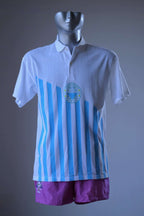 Löffler 90s men’s tennis polo in white with sky blue vertical stripes and a circular Championship Season’s Best print, displayed on a mannequin, with a pair of purple shorts.