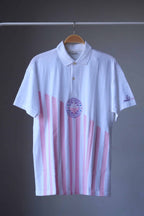 Löffler 90s men’s tennis polo in white with pink vertical stripes and a purple Championship Season’s Best badge, front view