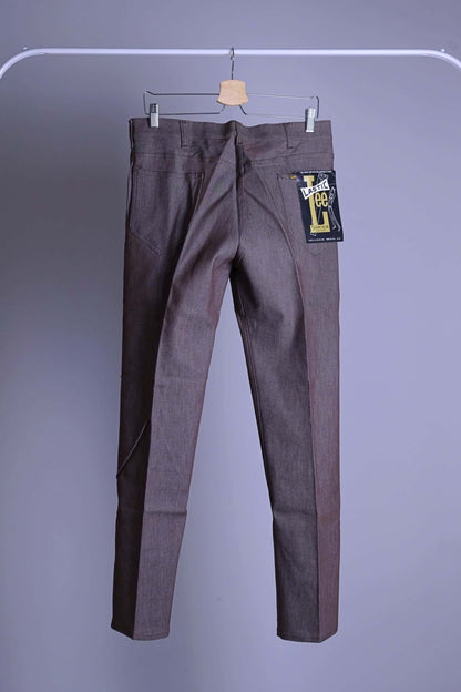 Vintage 70s Lee Leens Lastic Stretch trousers in dark heather brown, back view, showing the original 'Lastic Lee' product tag on the back pocket.