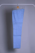 NOS 70s Lee Leens Lastic Stretch denim trousers in light sky blue, shown folded and hanging on a rack.