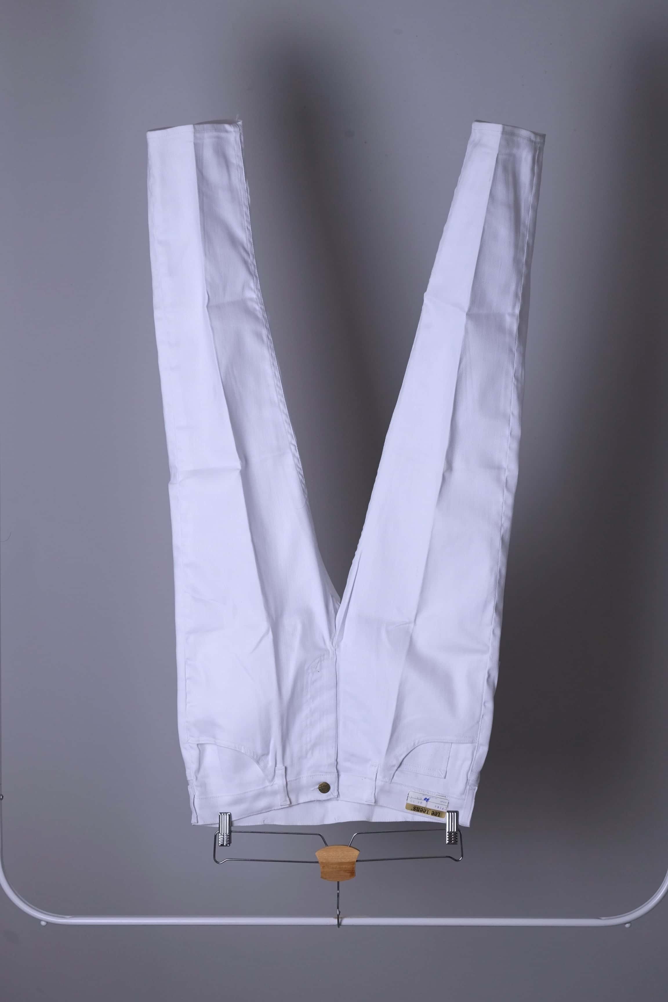 Clean, full-front view of NOS 70s white Lee Leens stretch trousers hanging on a rack.