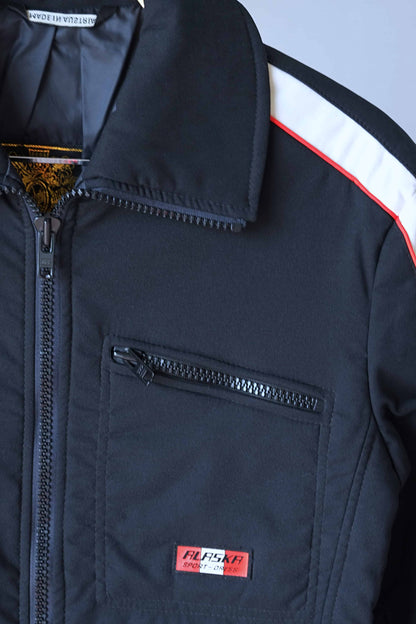 Close view of zipper pocket and collar of black 70's Retro Ski Jacket