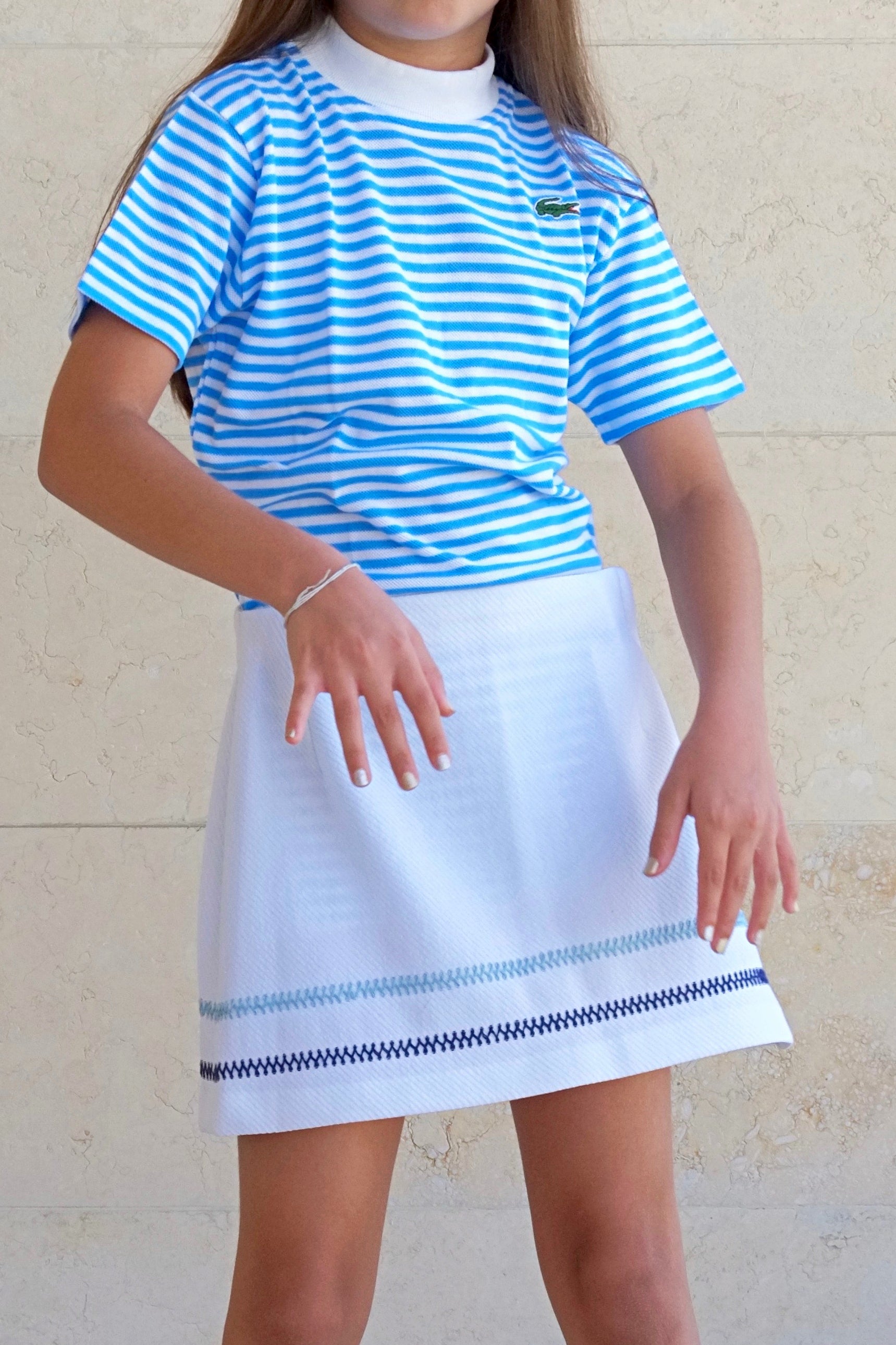 LACOSTE Striped Shirt in blue and white stripes worn by a girl in a white skirt