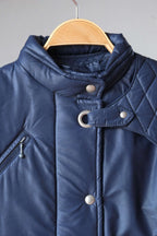 Close up view of Vintage navy 2-piece ski suit on hanger