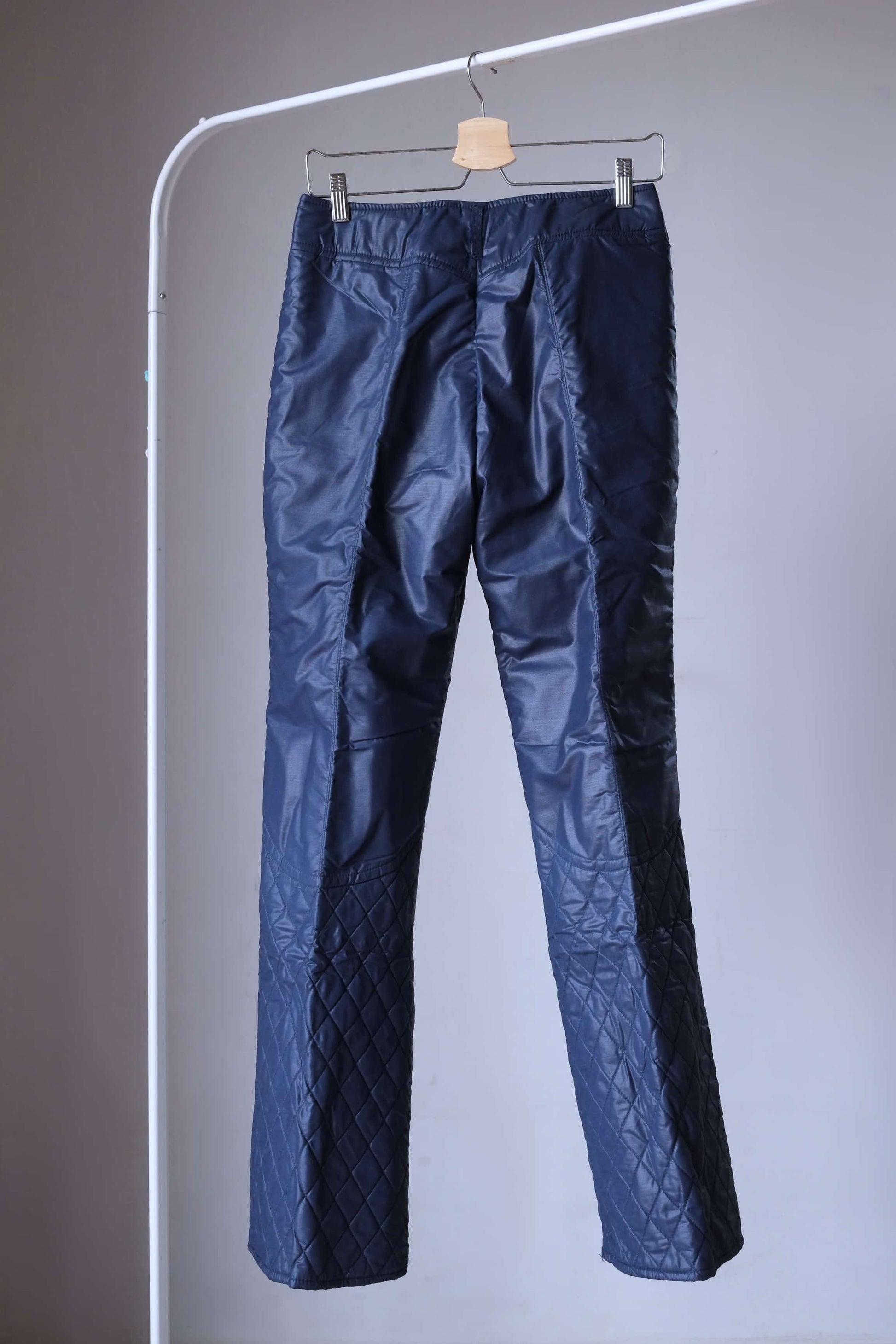 Back view of Vintage navy ski pants of 2-peice ski suit on hanger