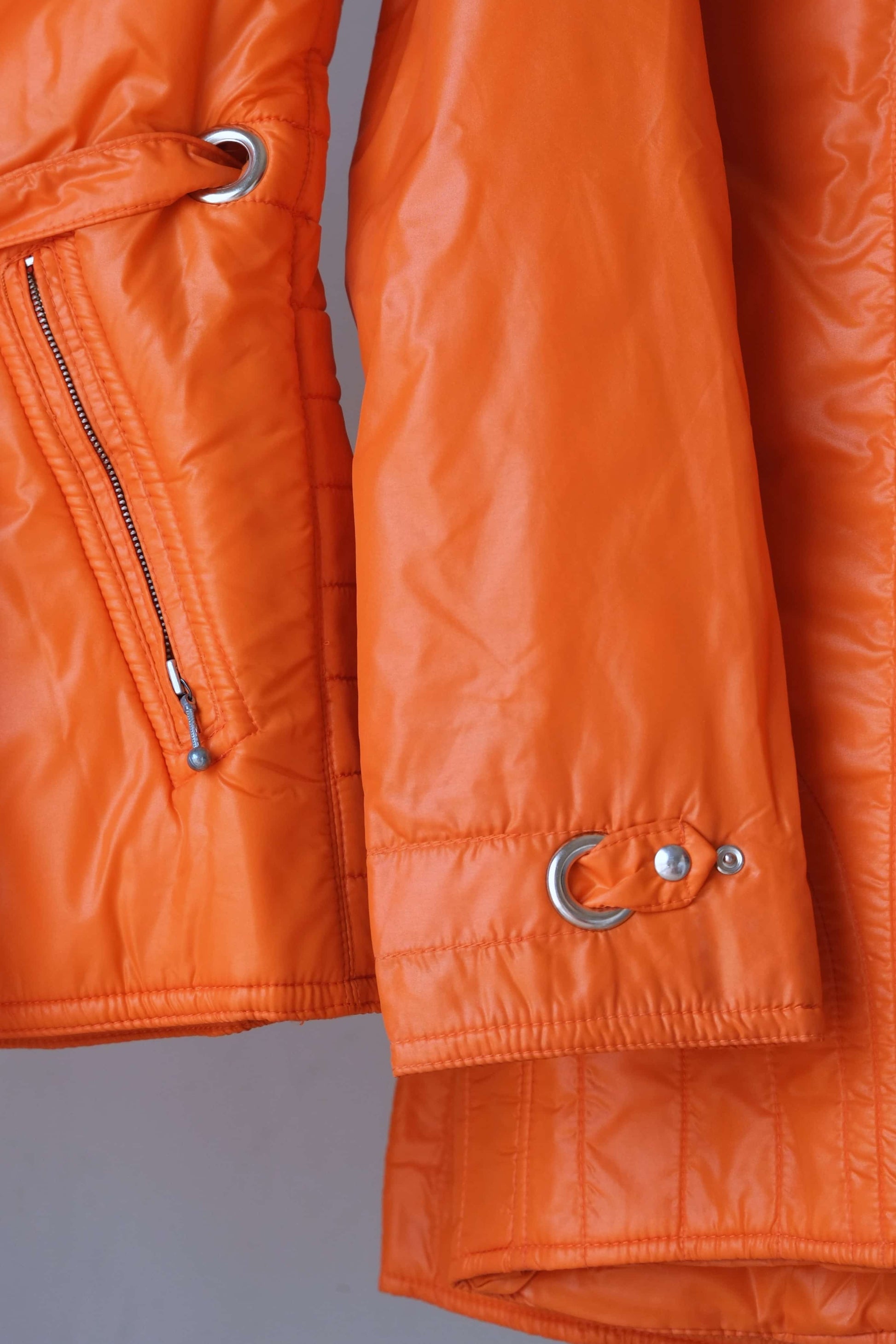 Close up sleeve detail of an orange mossant vintage 70s ski jacket