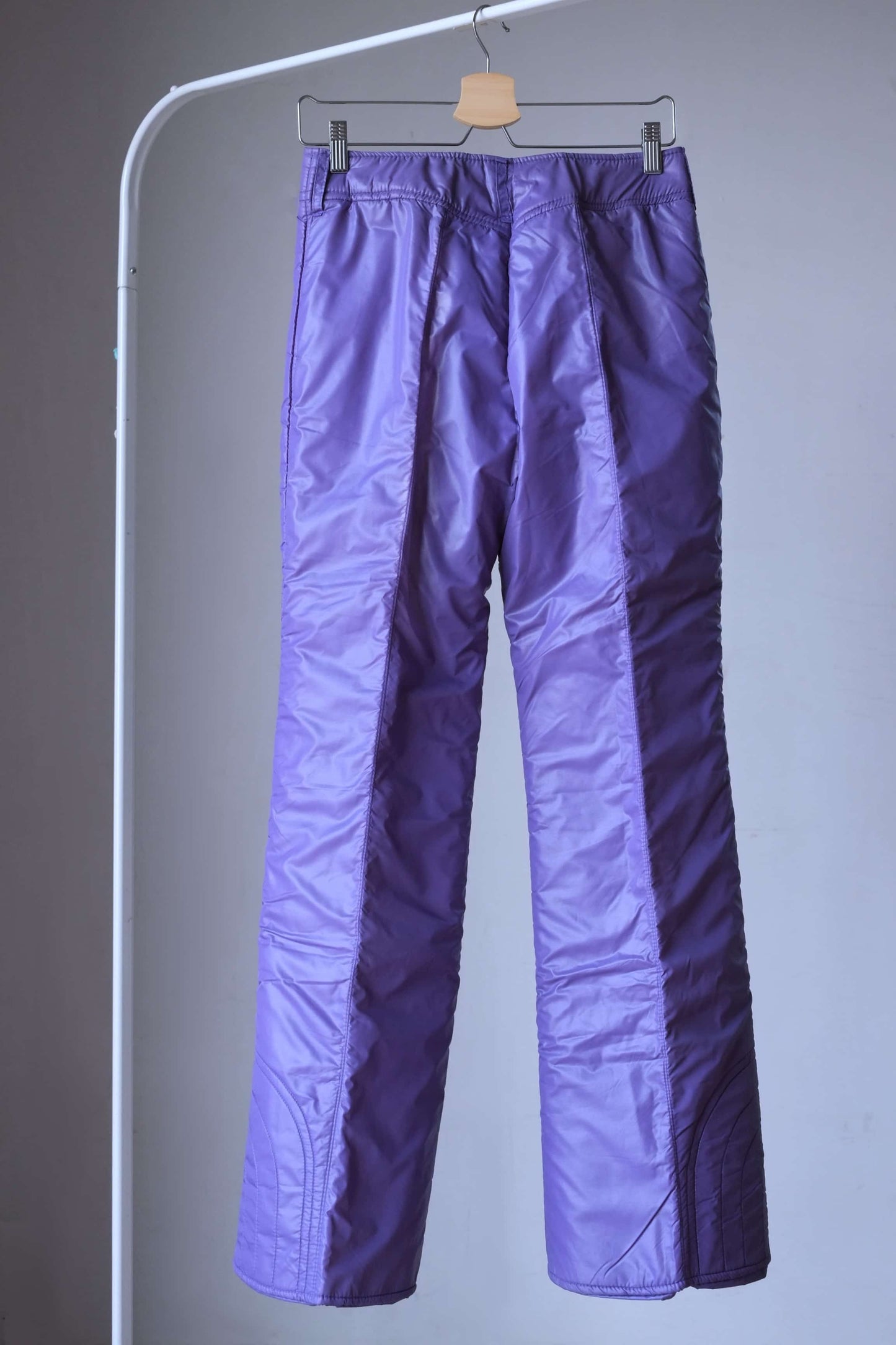 Back view of purple mossant vintage 70s women ski pants on hanger