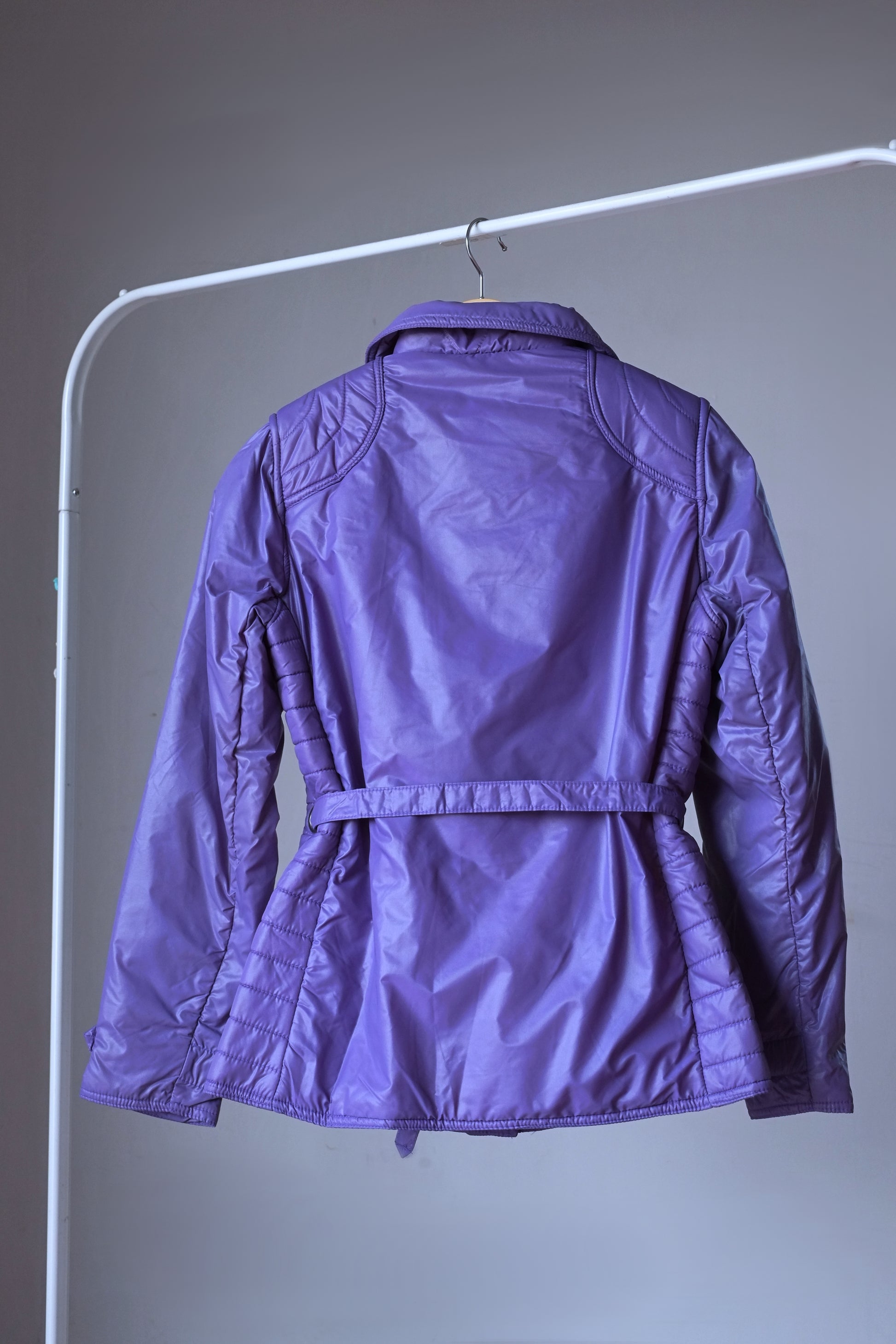 Back view of purple mossant 70s vintage women ski jacket on hanger