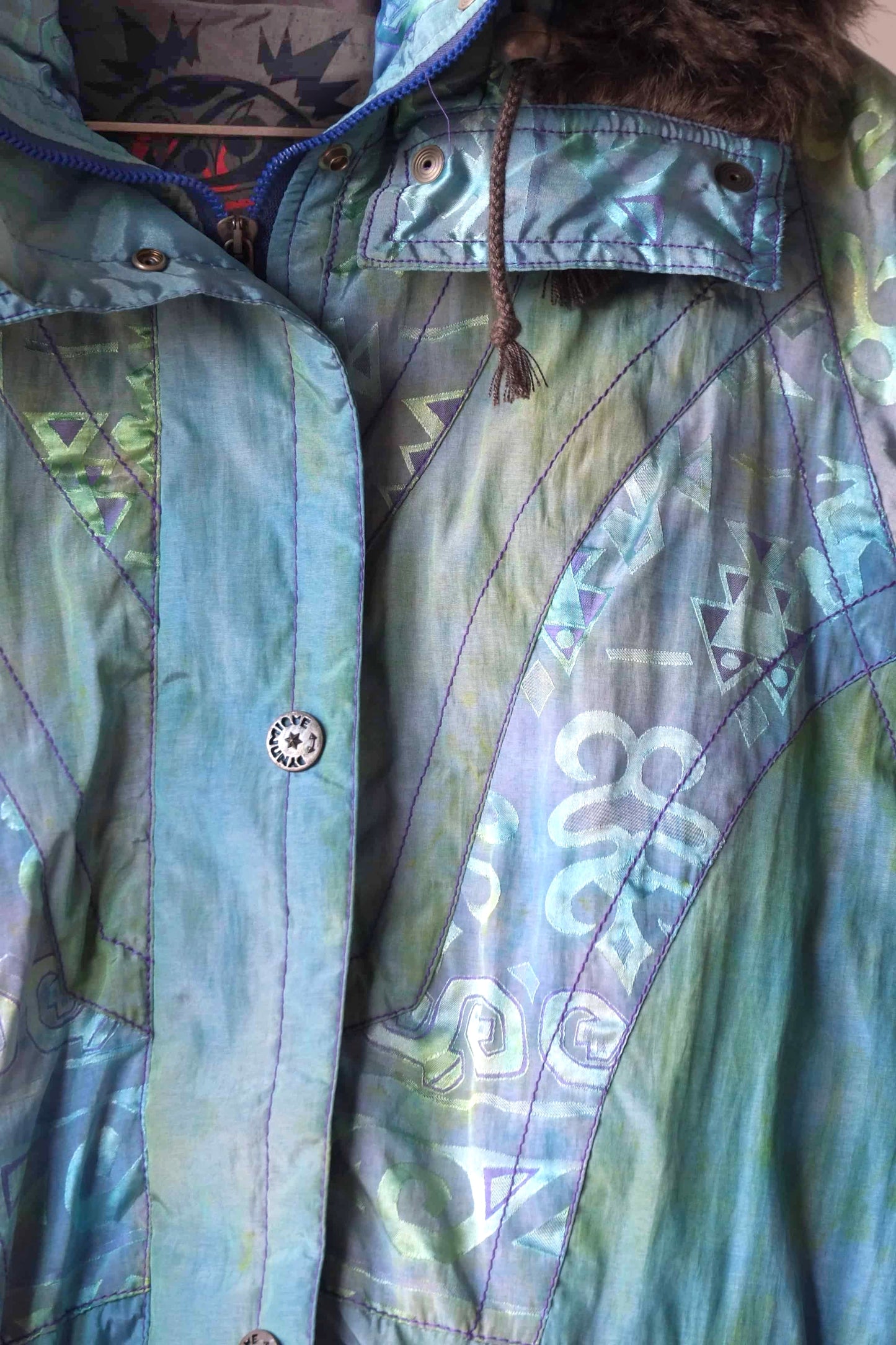 Close up of the fabric and details of a Vintage 90's Women's Ski Jacket in turquoise