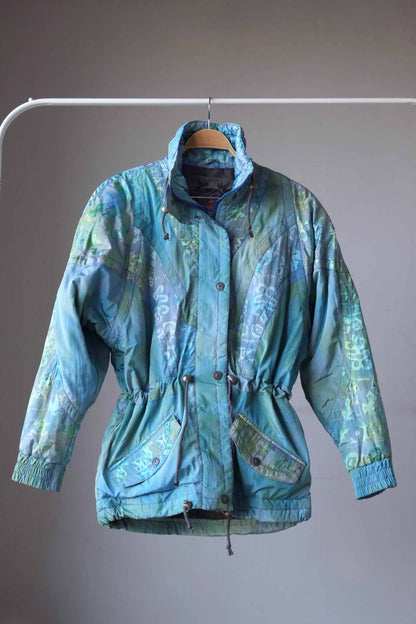 Vintage 90's Women's Ski Jacket in turquoise on hanger with hoodie removed