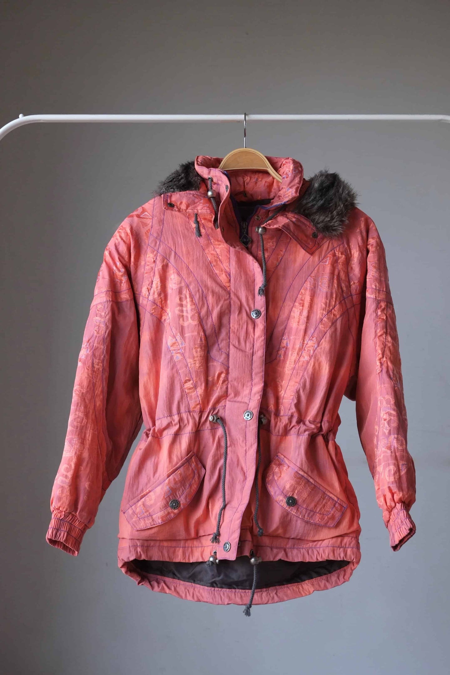 Vintage 90's Women's Ski Jacket in coral with fur lined hoodie on hanger
