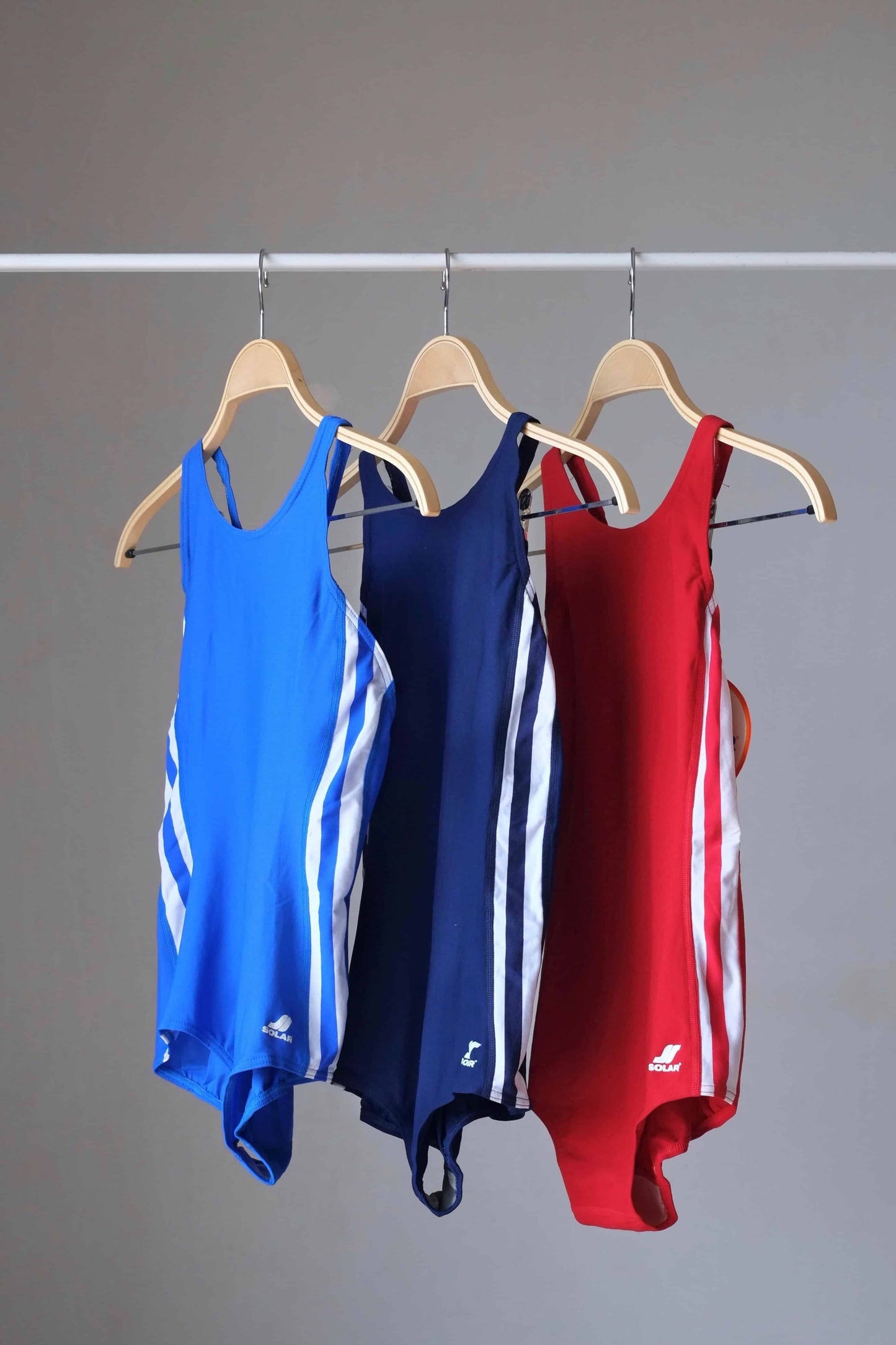 SOLAR 80's Classic Swimsuit blue, navy and red on hangers