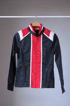 Front view of a vintage Sportalm ski jacket. The jacket is predominantly black with red and white stripes and a stand-up collar.