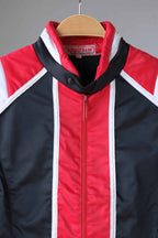 Close-up of the collar and label of a vintage Sportalm ski jacket. The jacket features a red and white striped collar and the Sportalm logo.