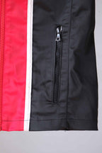 Close-up of the zippered pocket on a vintage Sportalm ski jacket, showing the red and black color-blocking.