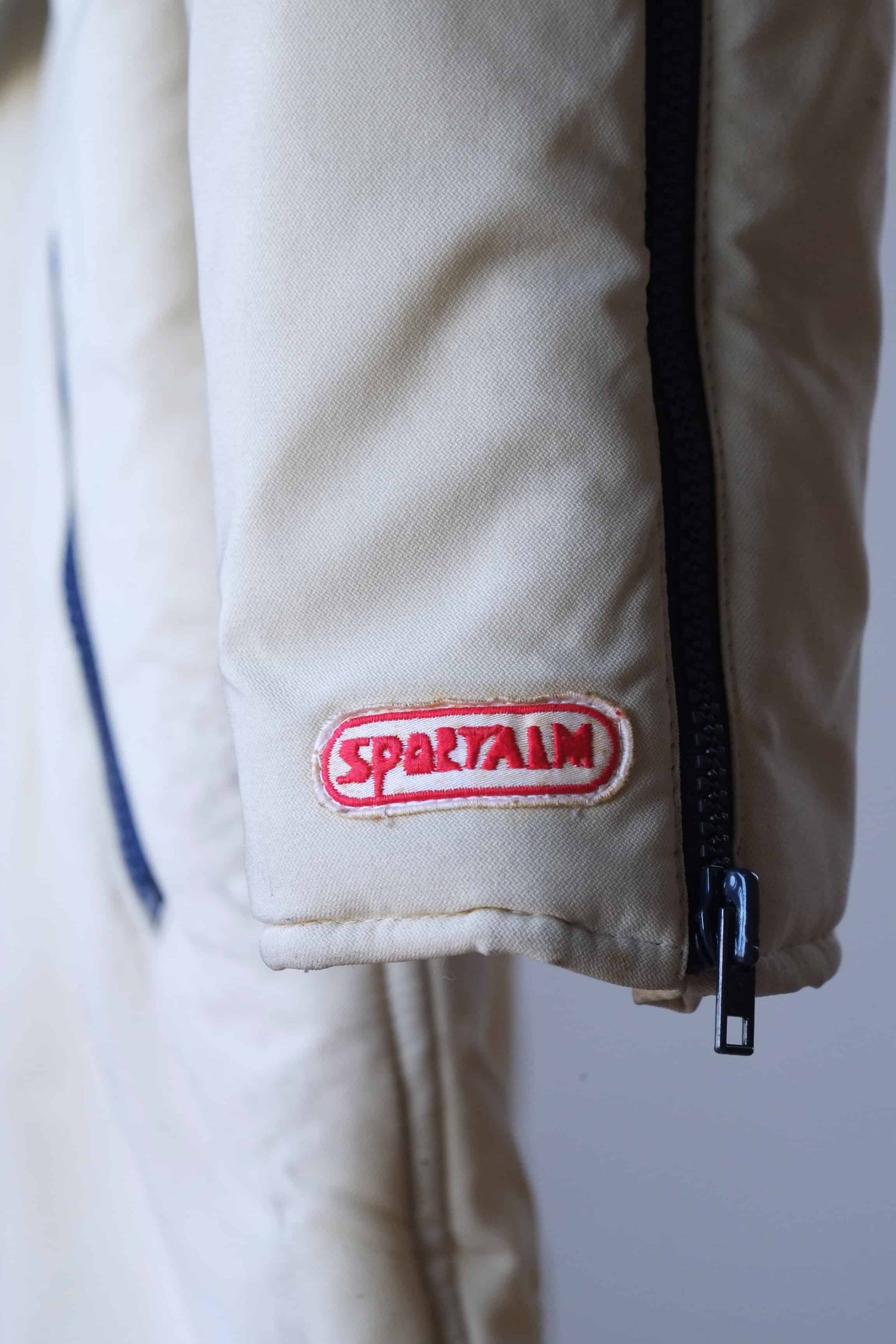 Close up view of the SPORTALM logo on the sleeve of a Vintage 60's Men's Ski Suit