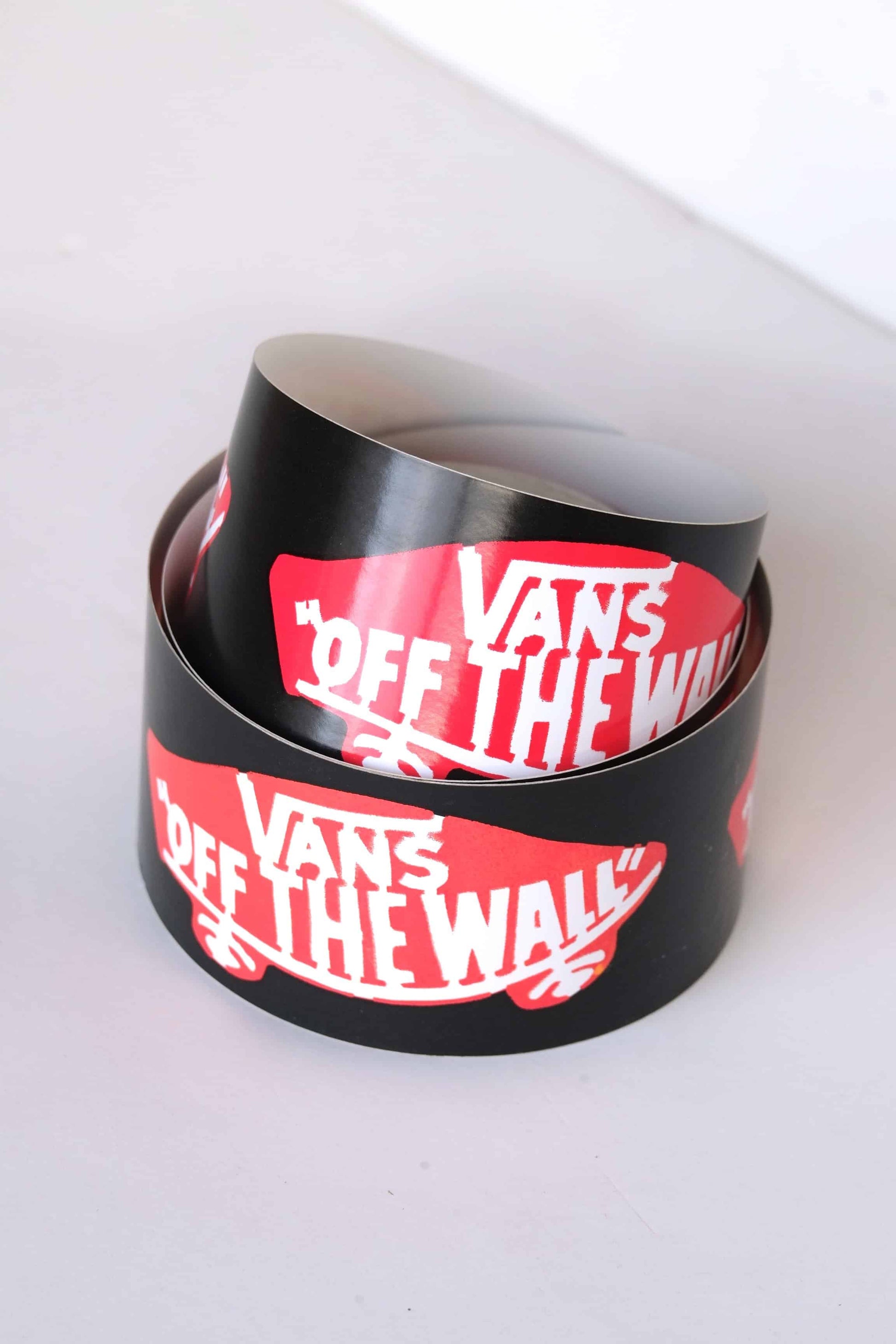 Close-up of vintage Vans Off The Wall logo adhesive tape roll, black with red and white branding, dealer promo from the 2000s