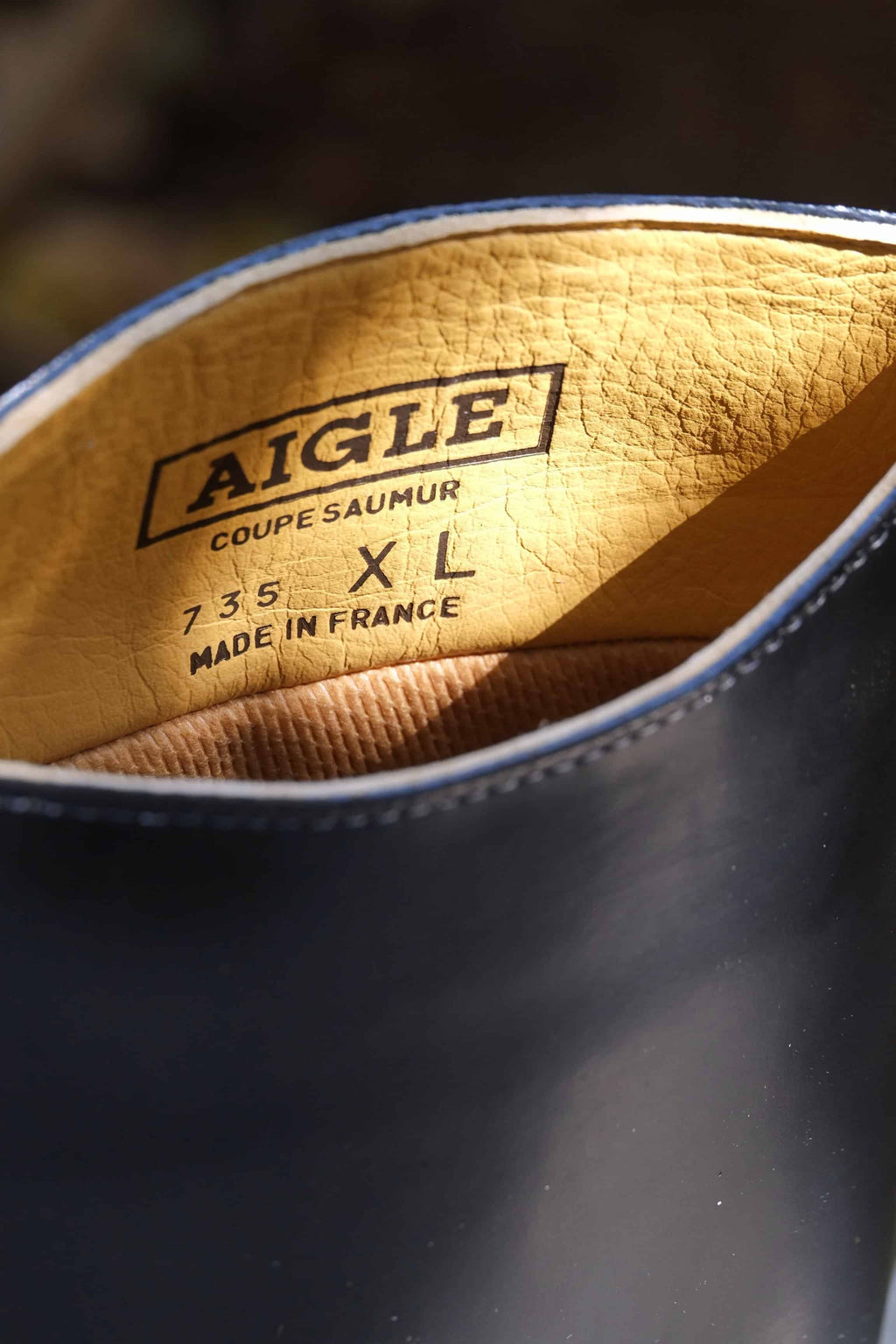 a close up shot of the inner lining of Aigle Ecuyer, the brand AIGLE is visible along with the size XL and the words 'made in France'