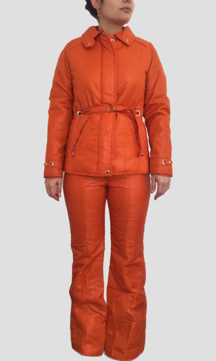 Model on white background wearing a mossant 70s vintage orange 2-piece ski suit